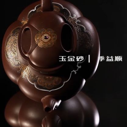 Decorative teapot with intricate designs on a black background